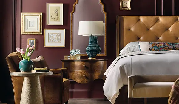 Archives collection bedroom with a leather headboard and warm wood case pieces