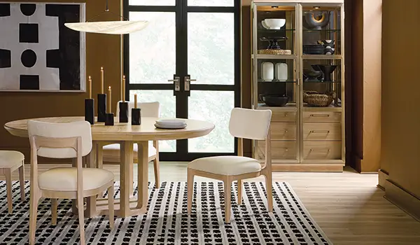 Banyon Bay collection dining setting with light oak furniture and a patterned rug