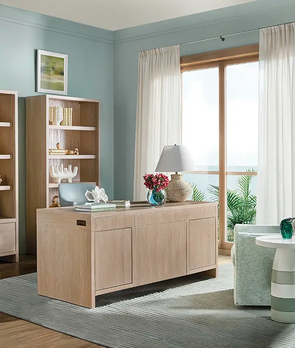 Pale wood desk and console in a bright home office