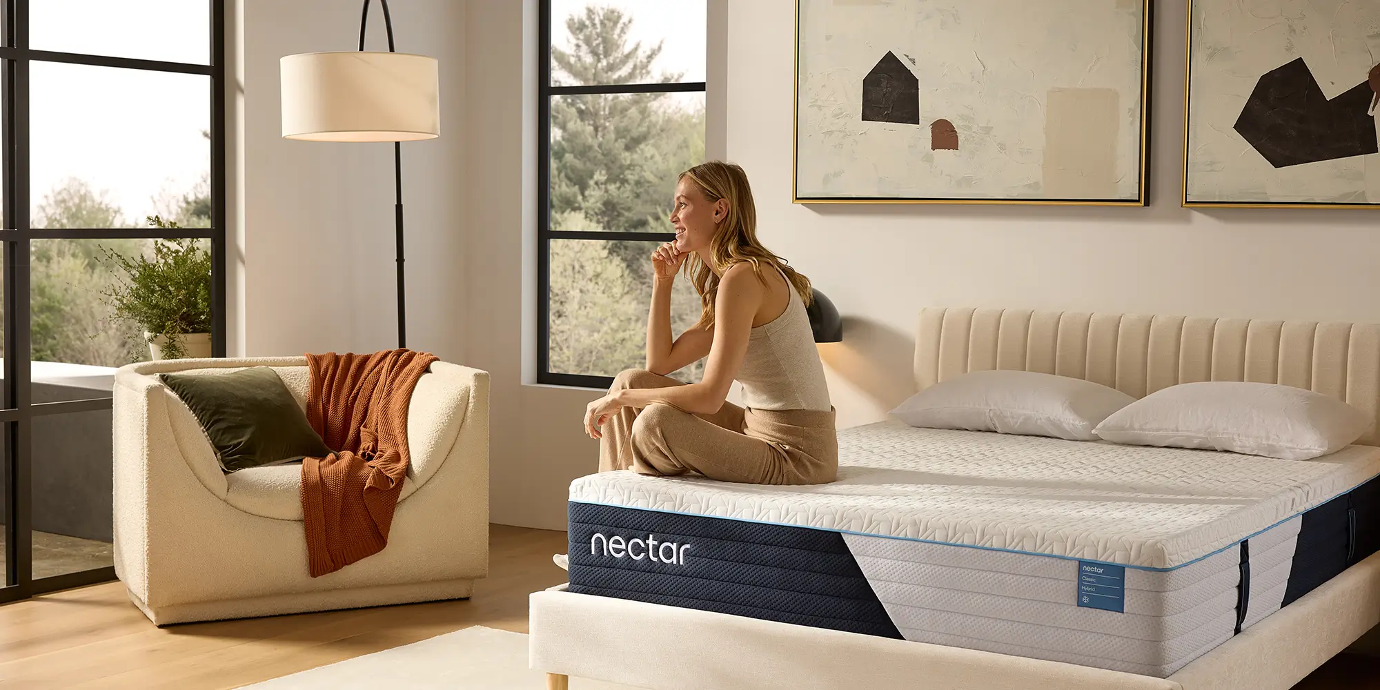 A customer sitting on a Nectar mattress